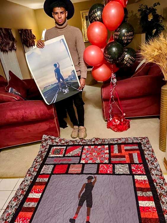 young man standing in front of red and black quilt with image used as the inspiration